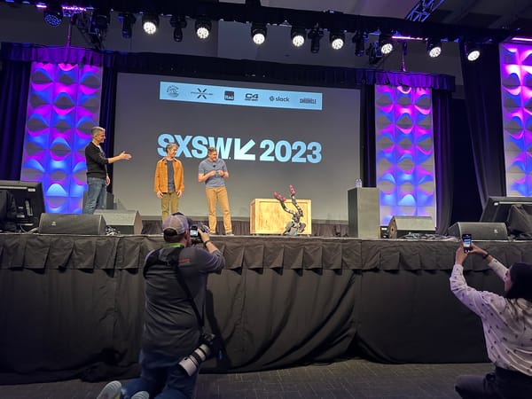 Walt Disney Imagineers and Walt Disney Chairman of Parks Josh D'Amaro demonstrating a new robot on stage at SXSW